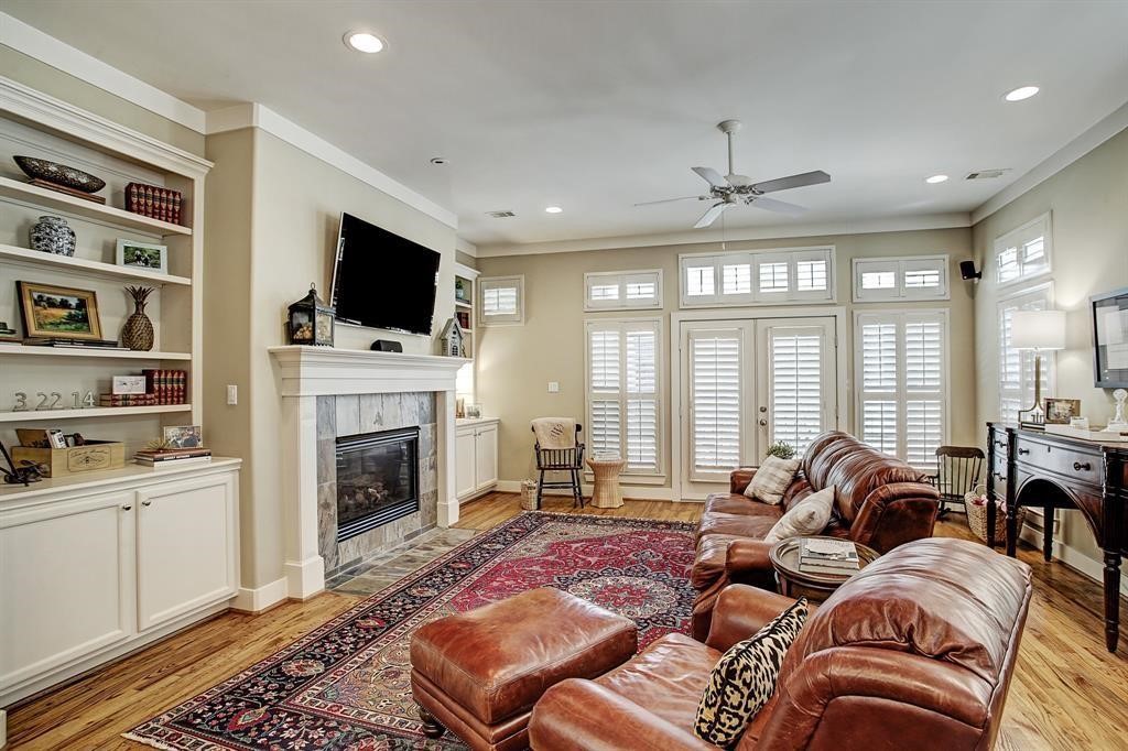 246 Detering Street Houston, TX 77007 - Photo 7 of 27 a living room with furniture a flat screen tv and a fireplace