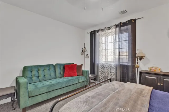 a bedroom with a bed and ceiling fan