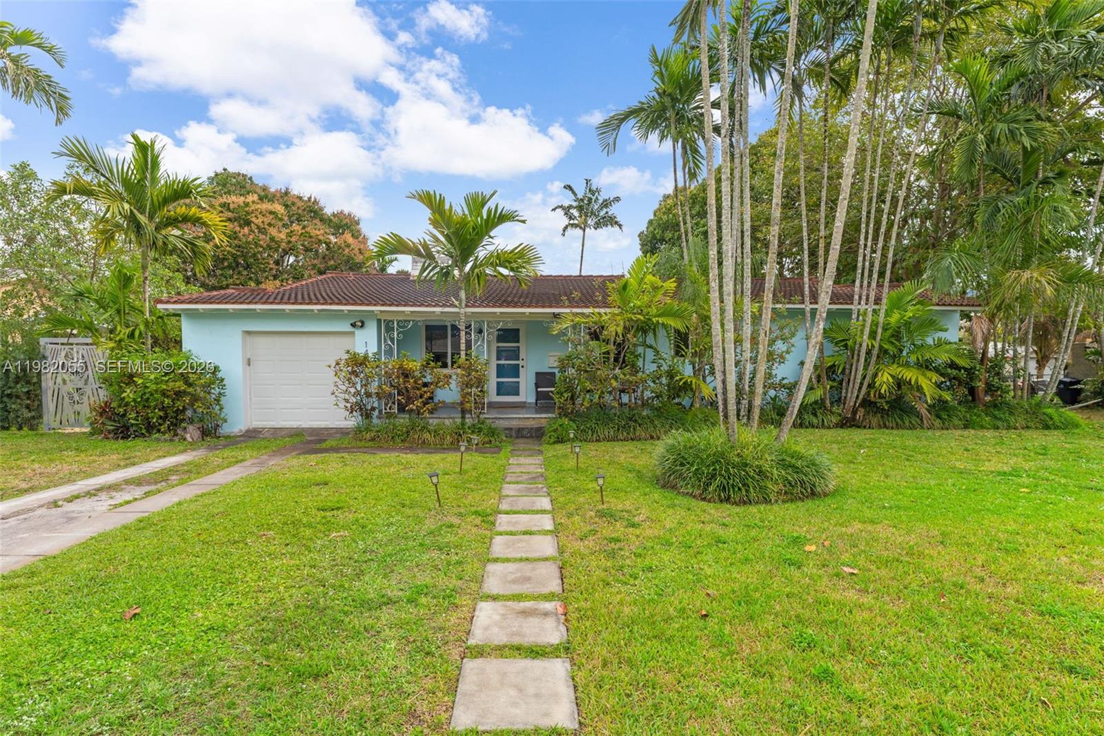 149 Fern Way Miami Springs, FL 33166 - Photo 1 of 35 a front view of a house with garden