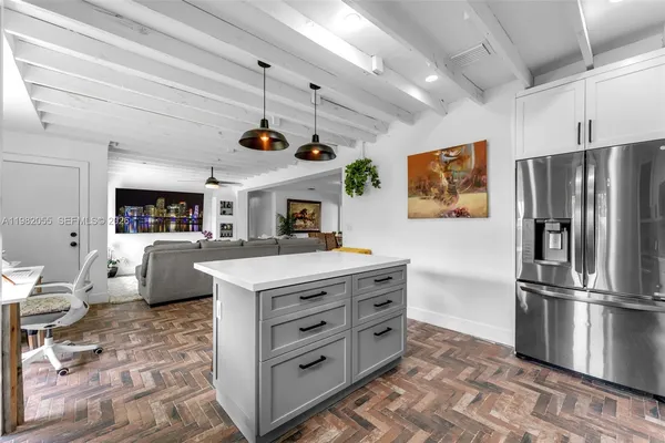 a kitchen with stainless steel appliances a stove a refrigerator and a refrigerator