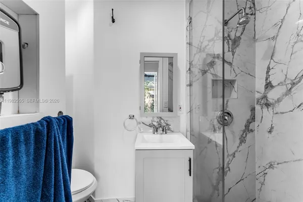 a bathroom with a toilet sink and mirror