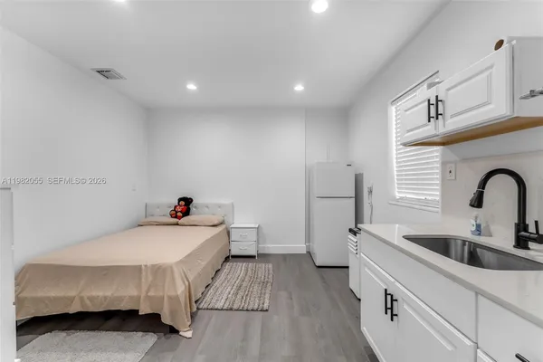 a kitchen with a sink and a wooden floor