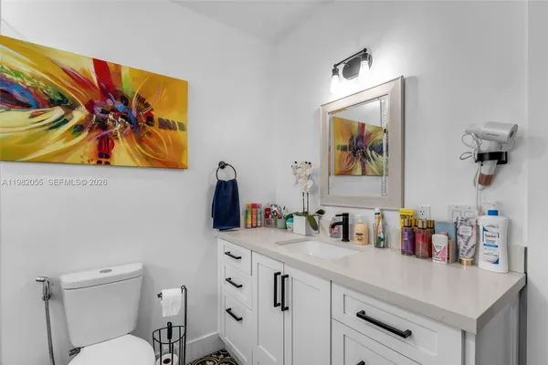 a bathroom with a sink mirror and vanity