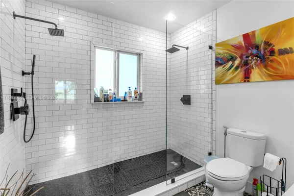 a bathroom with a shower a toilet and a shower