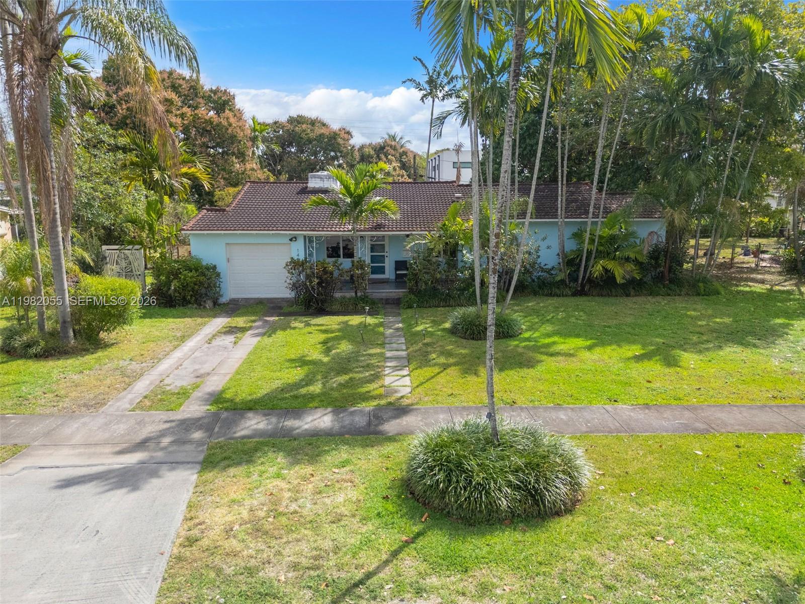 149 Fern Way Miami Springs, FL 33166 - Photo 2 of 35 a view of a house with a swimming pool