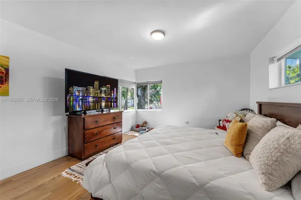 a bedroom with a bed and a television in it