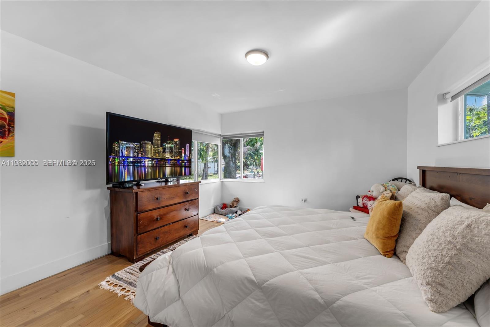 149 Fern Way Miami Springs, FL 33166 - Photo 23 of 35 a bedroom with a bed and a television in it