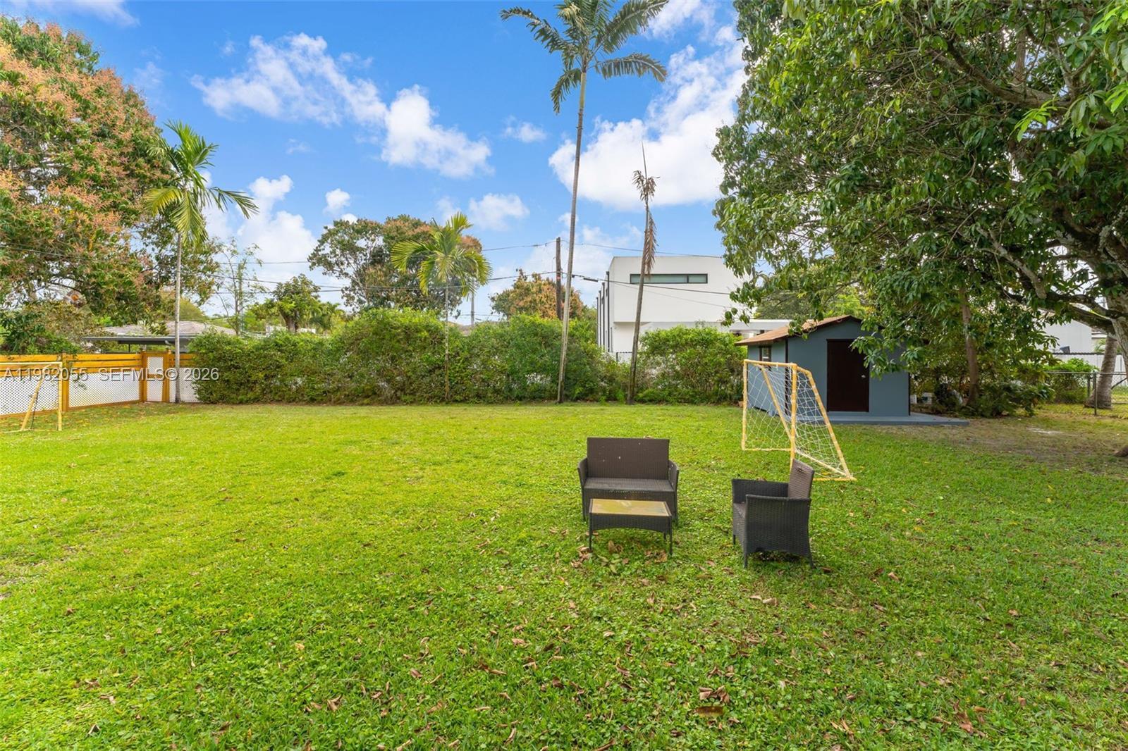 149 Fern Way Miami Springs, FL 33166 - Photo 24 of 35 a view of a garden with a bench