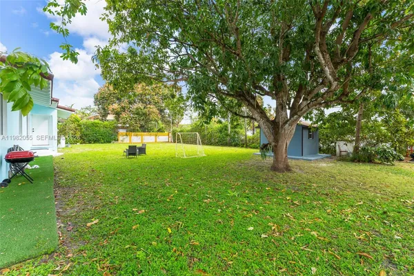 a view of green field with tree s