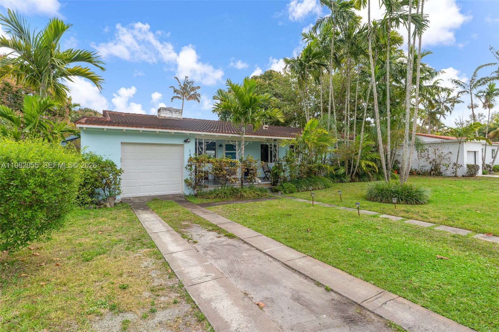 149 Fern Way Miami Springs, FL 33166 - Photo 4 of 35 a front view of a house with garden