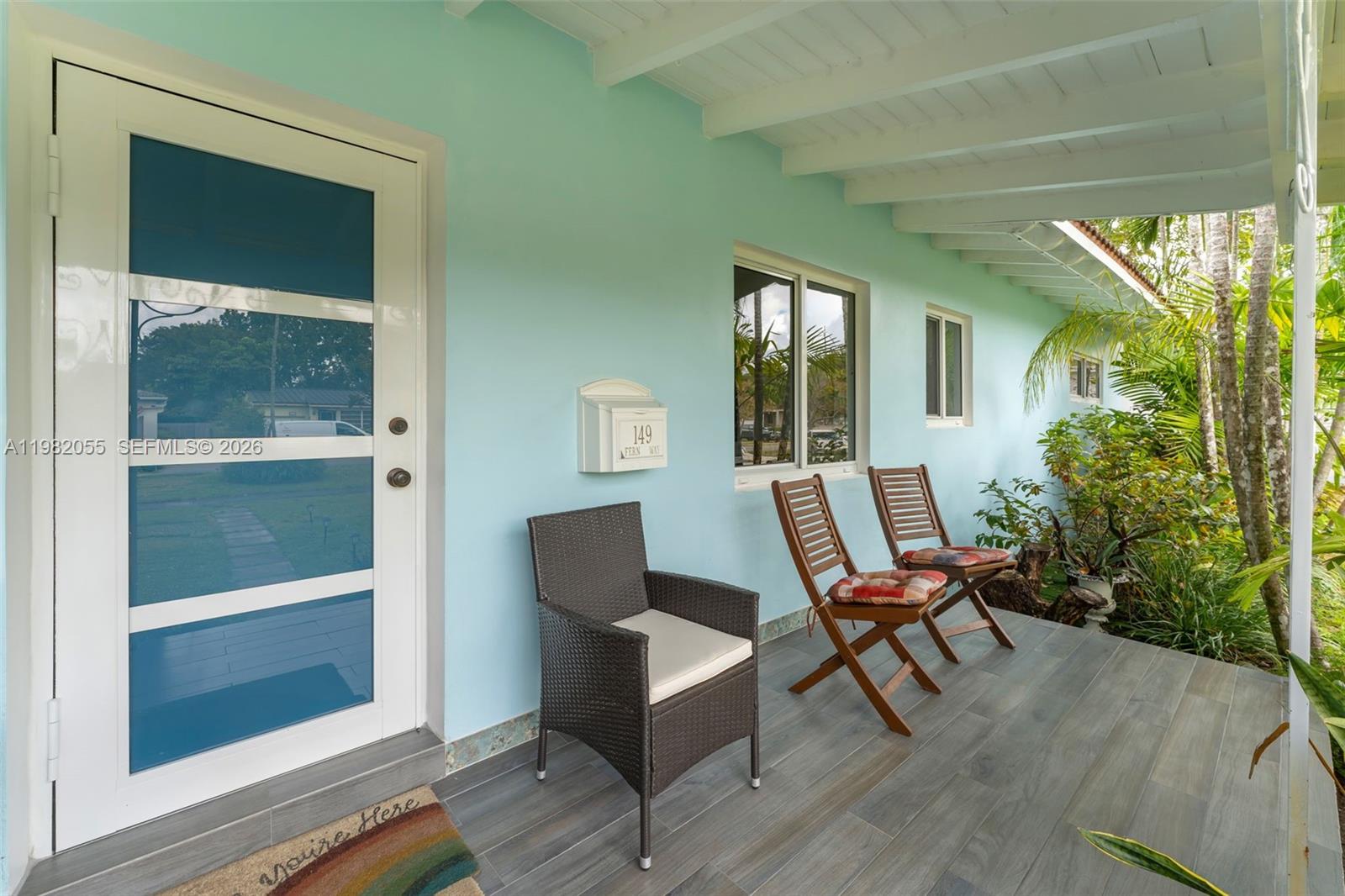 149 Fern Way Miami Springs, FL 33166 - Photo 5 of 35 a roof deck with table and chairs and potted plants