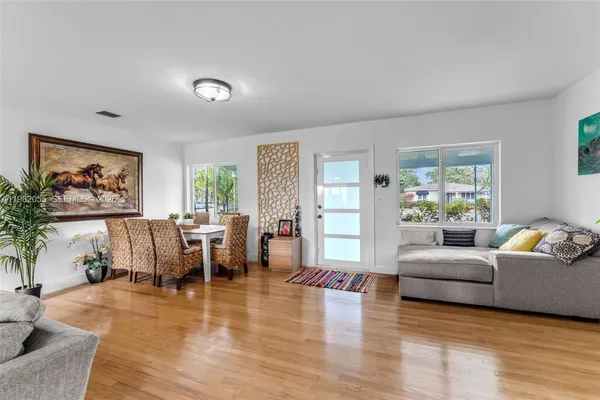 a living room with furniture and a wooden floor
