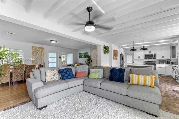 a view of a living room kitchen and a wooden floor