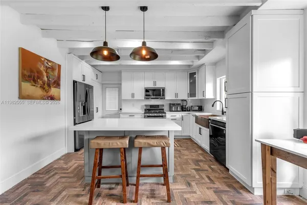 a kitchen with a center island and stainless steel appliances