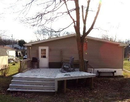 629 Deana Way Rochester, PA 15074 - Photo 5 of 23 a backyard of a house with barbeque oven and large trees