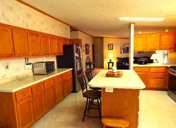 629 Deana Way Rochester, PA 15074 - Photo 7 of 23 a kitchen with stainless steel appliances wooden cabinets a stove a sink and a refrigerator