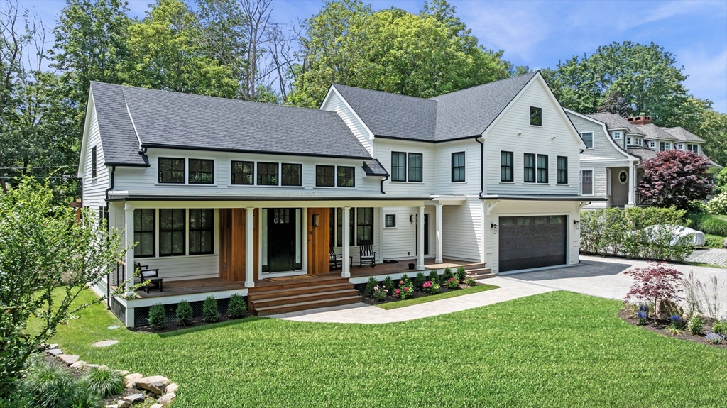 a view of a house with a yard and sitting area