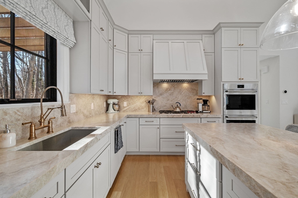 16 Liberty Road Marblehead, MA 01945 - Photo 8 of 29 a kitchen with stainless steel appliances granite countertop a sink stove and refrigerator