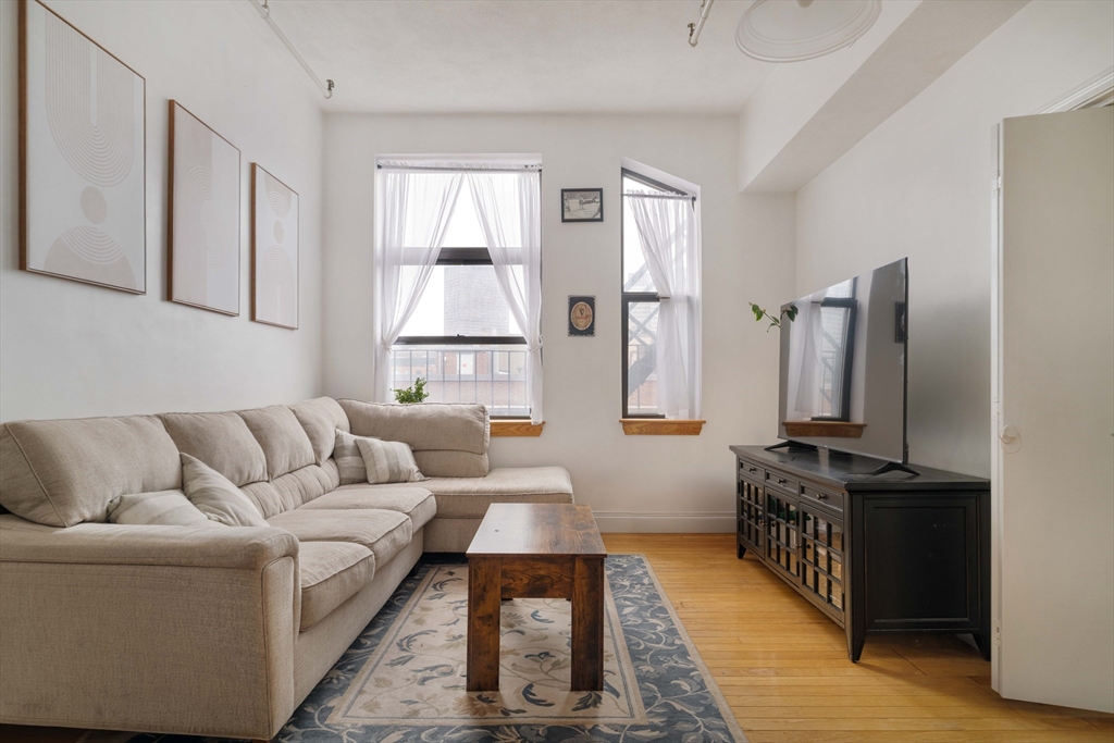 188 North Street, Unit 42 Boston, MA 02113 - Photo 5 of 19 a living room with furniture and a flat screen tv