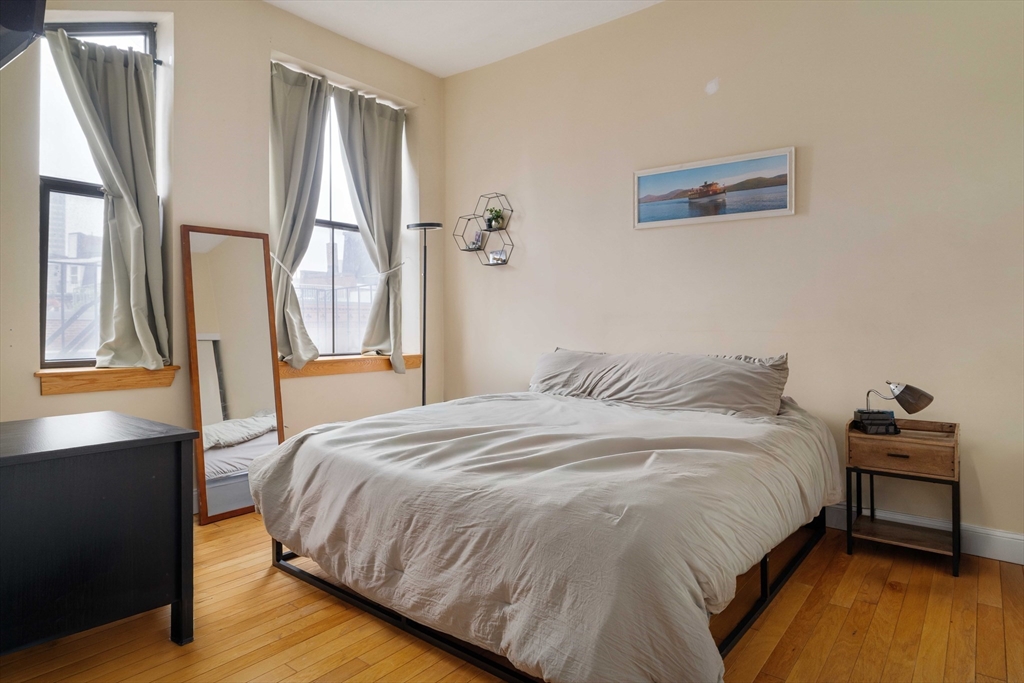 188 North Street, Unit 42 Boston, MA 02113 - Photo 7 of 19 a bedroom with a bed and wooden floor