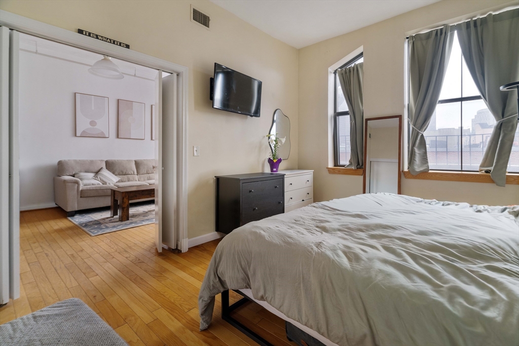 188 North Street, Unit 42 Boston, MA 02113 - Photo 8 of 19 a bedroom with a bed and a flat tv screen on dresser