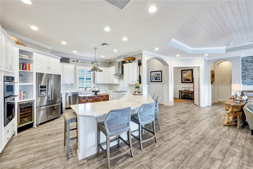 9206 Marble Stone Drive Naples, FL 34120 - Photo 15 of 50 a dining room with furniture and wooden floor