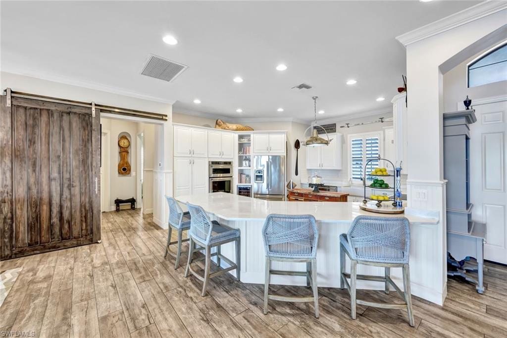 9206 Marble Stone Drive Naples, FL 34120 - Photo 16 of 50 a view of kitchen and dining area with furniture