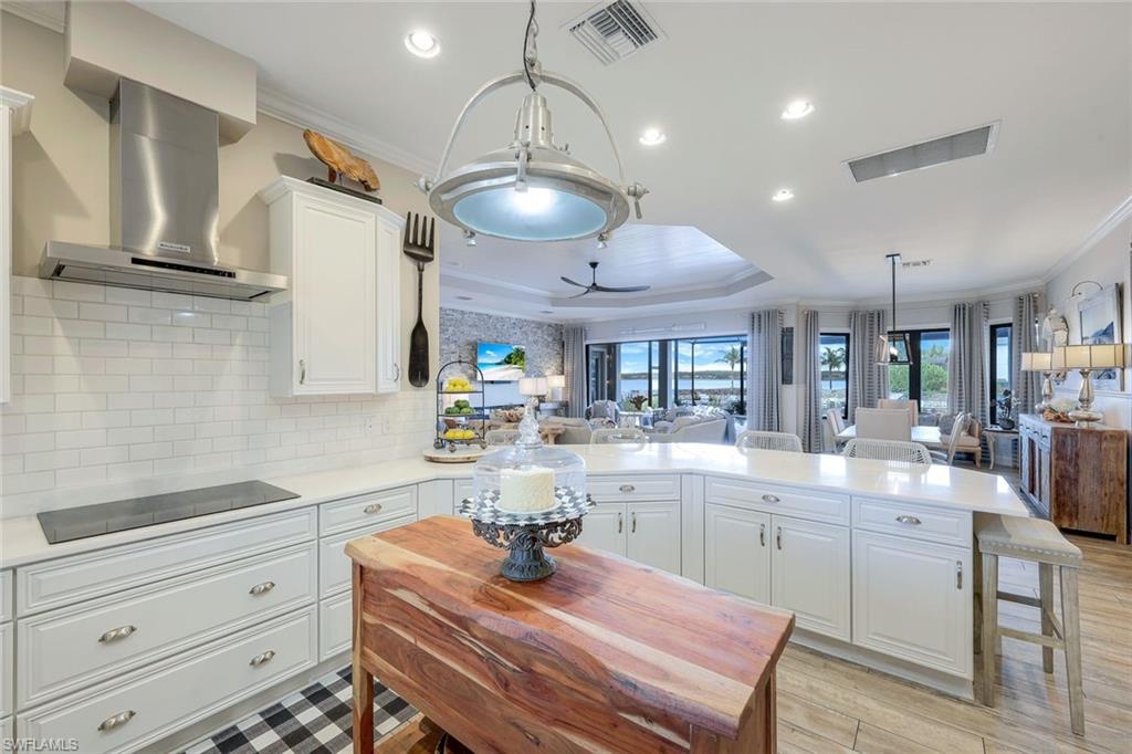 9206 Marble Stone Drive Naples, FL 34120 - Photo 19 of 50 a kitchen with cabinets appliances and a chandelier