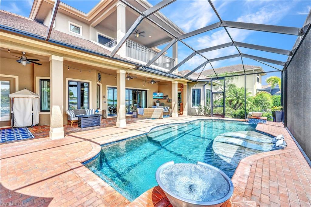 9206 Marble Stone Drive Naples, FL 34120 - Photo 2 of 50 a view of a swimming pool with a patio