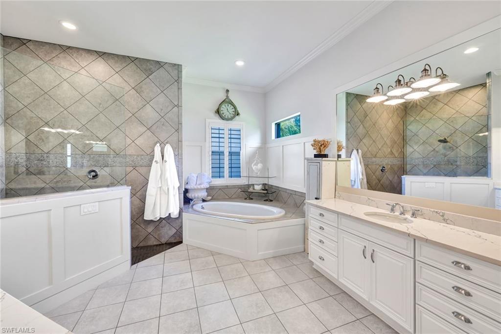 9206 Marble Stone Drive Naples, FL 34120 - Photo 25 of 50 a bathroom with a sink a toilet and bathtub