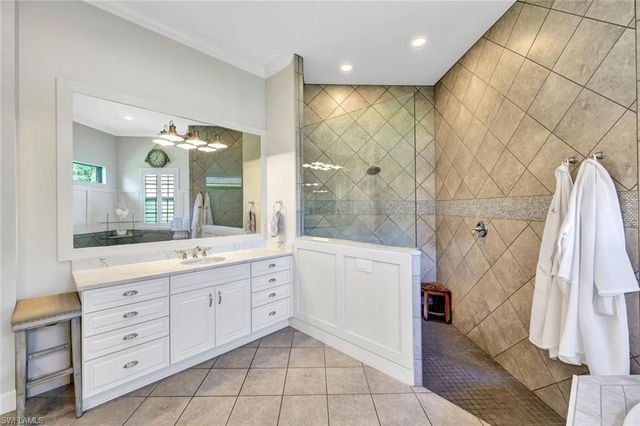 a spacious bathroom with a double vanity sink a mirror and a shower