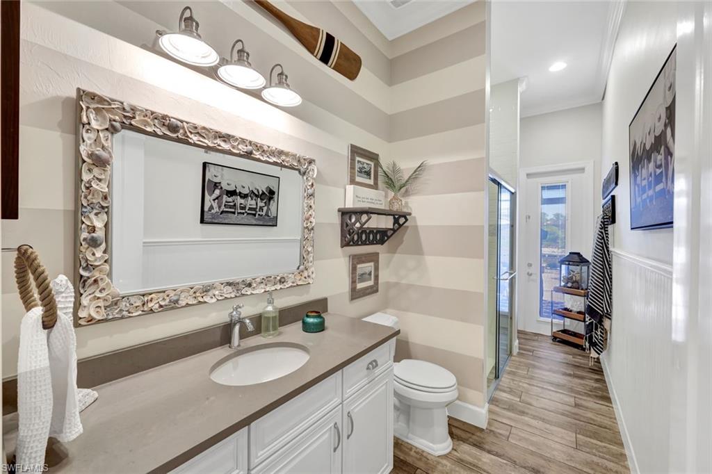 9206 Marble Stone Drive Naples, FL 34120 - Photo 28 of 50 a bathroom with a granite countertop toilet sink and mirror