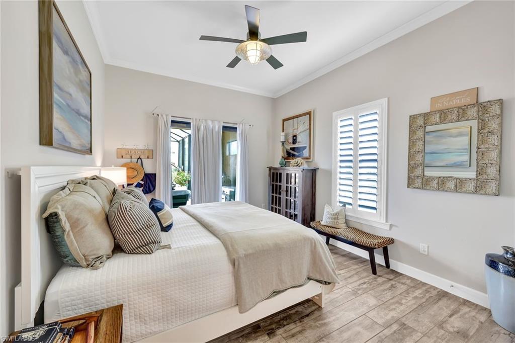 9206 Marble Stone Drive Naples, FL 34120 - Photo 29 of 50 a bedroom with a bed and a chandelier