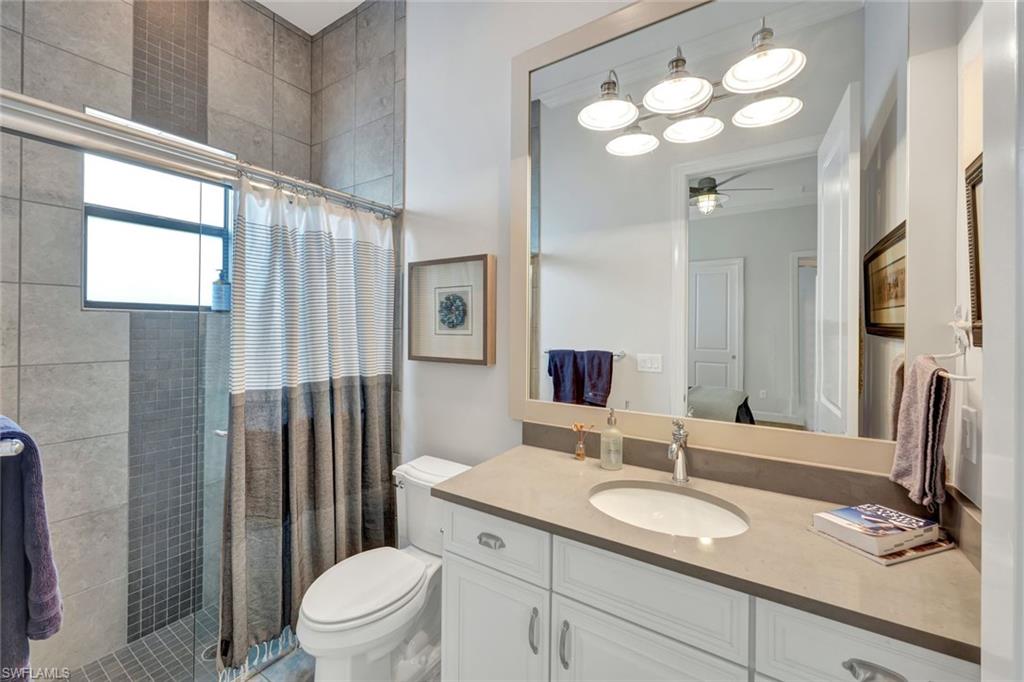 9206 Marble Stone Drive Naples, FL 34120 - Photo 30 of 50 a bathroom with a granite countertop sink toilet and mirror