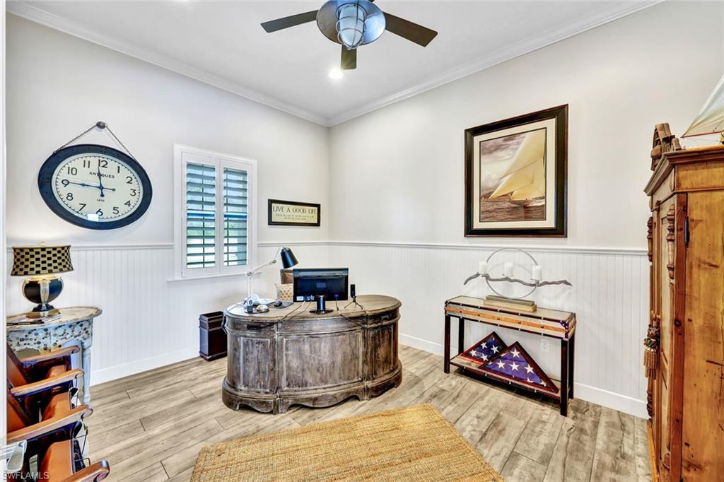 9206 Marble Stone Drive Naples, FL 34120 - Photo 31 of 50 a living room with furniture and a clock