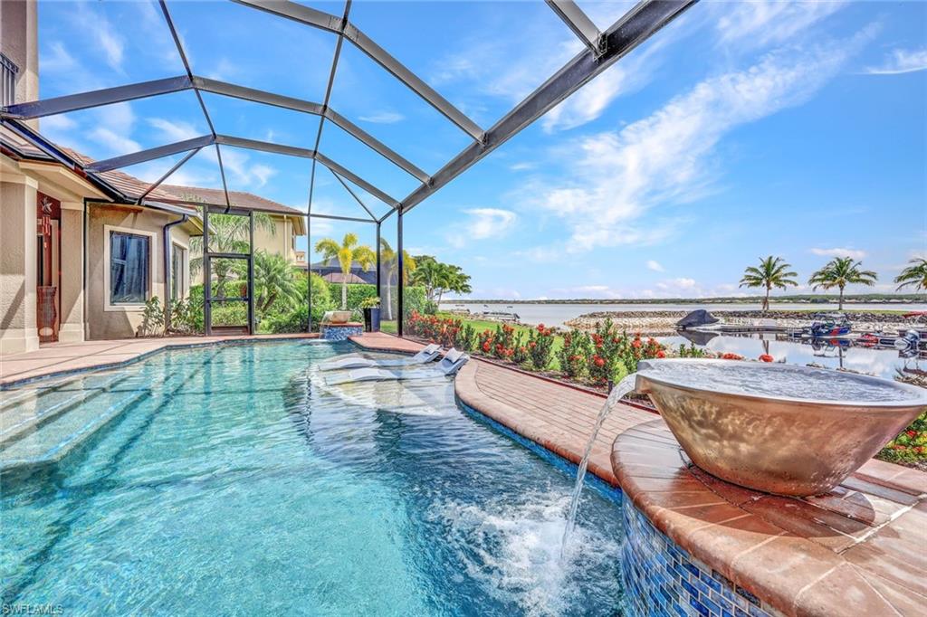 9206 Marble Stone Drive Naples, FL 34120 - Photo 37 of 50 a view of a swimming pool with a patio