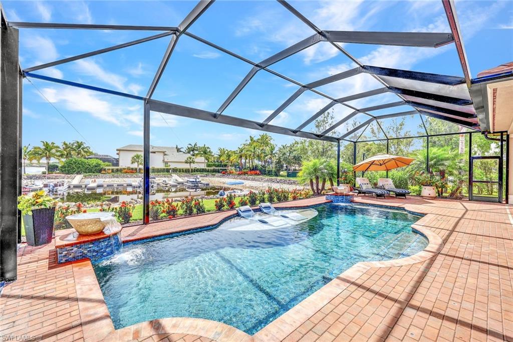 9206 Marble Stone Drive Naples, FL 34120 - Photo 38 of 50 a view of a swimming pool with a porch