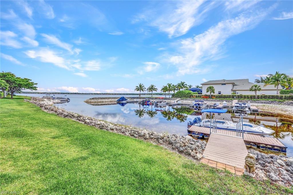 9206 Marble Stone Drive Naples, FL 34120 - Photo 43 of 50 a view of a lake with a yard and outdoor seating