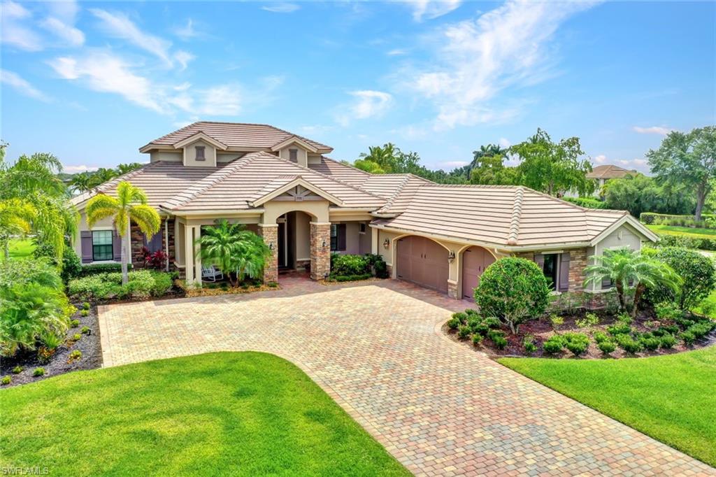 9206 Marble Stone Drive Naples, FL 34120 - Photo 7 of 50 a front view of a house with a garden and plants