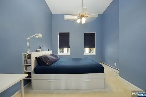 a living room with a bed and a chandelier