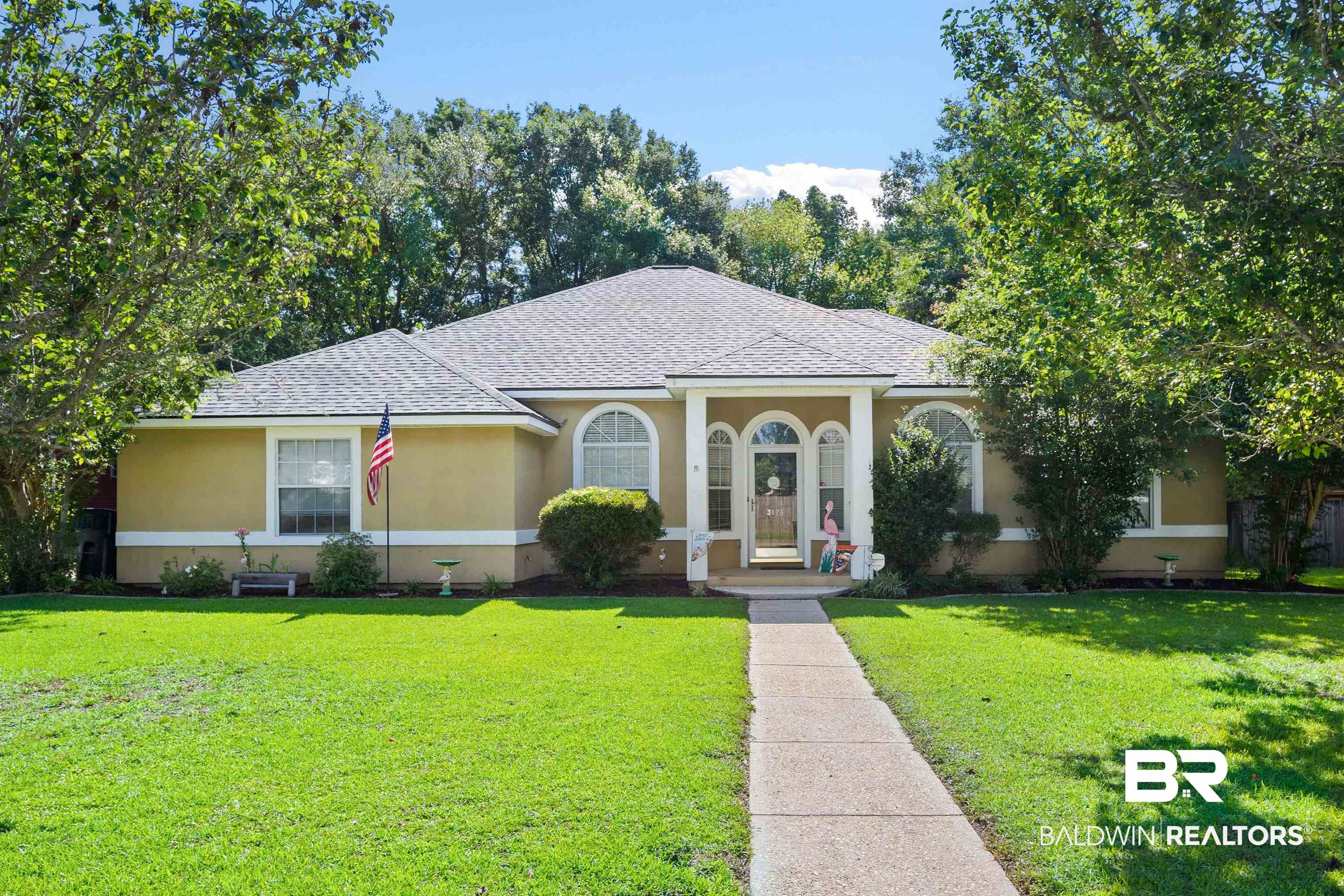 3075 Azalea Trace Drive Mobile, AL 36695 - Photo 1 of 33 View of front facade with stucco siding, a front lawn, a shingled roof, and central AC