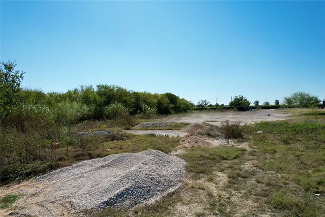 a view of a field with an ocean