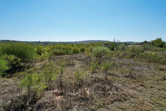 a view of a large building with a mountain in the background
