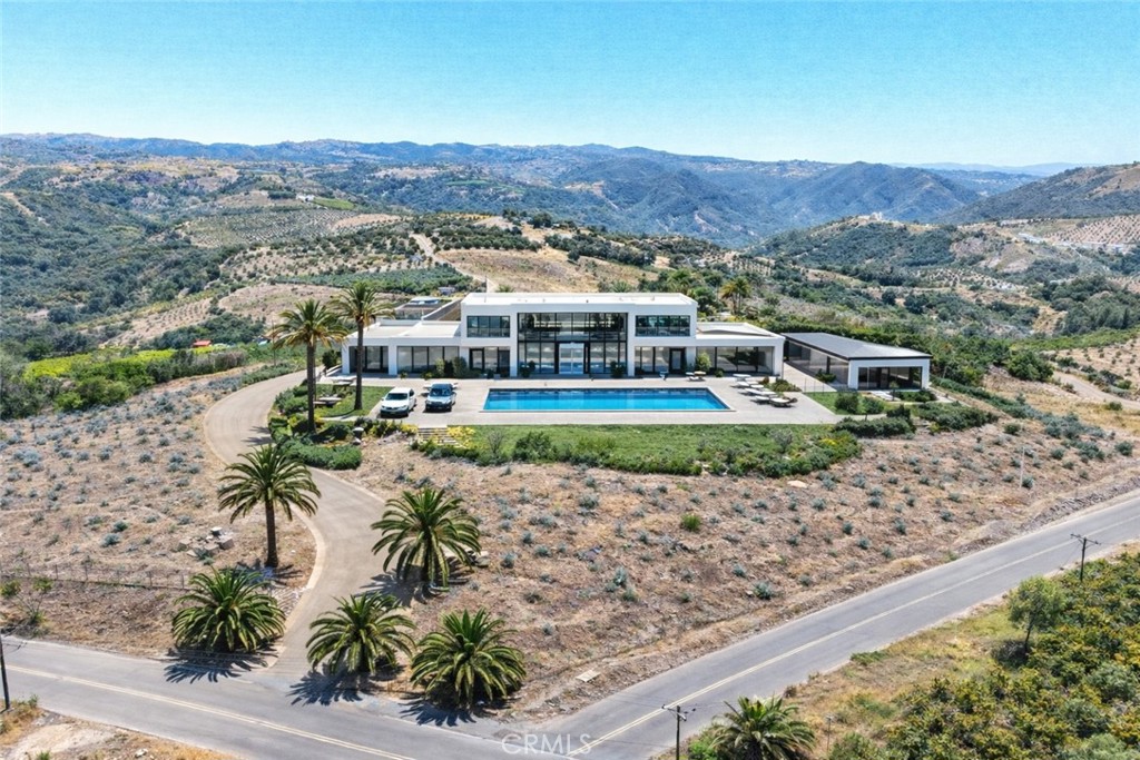 an aerial view of residential houses and lake view