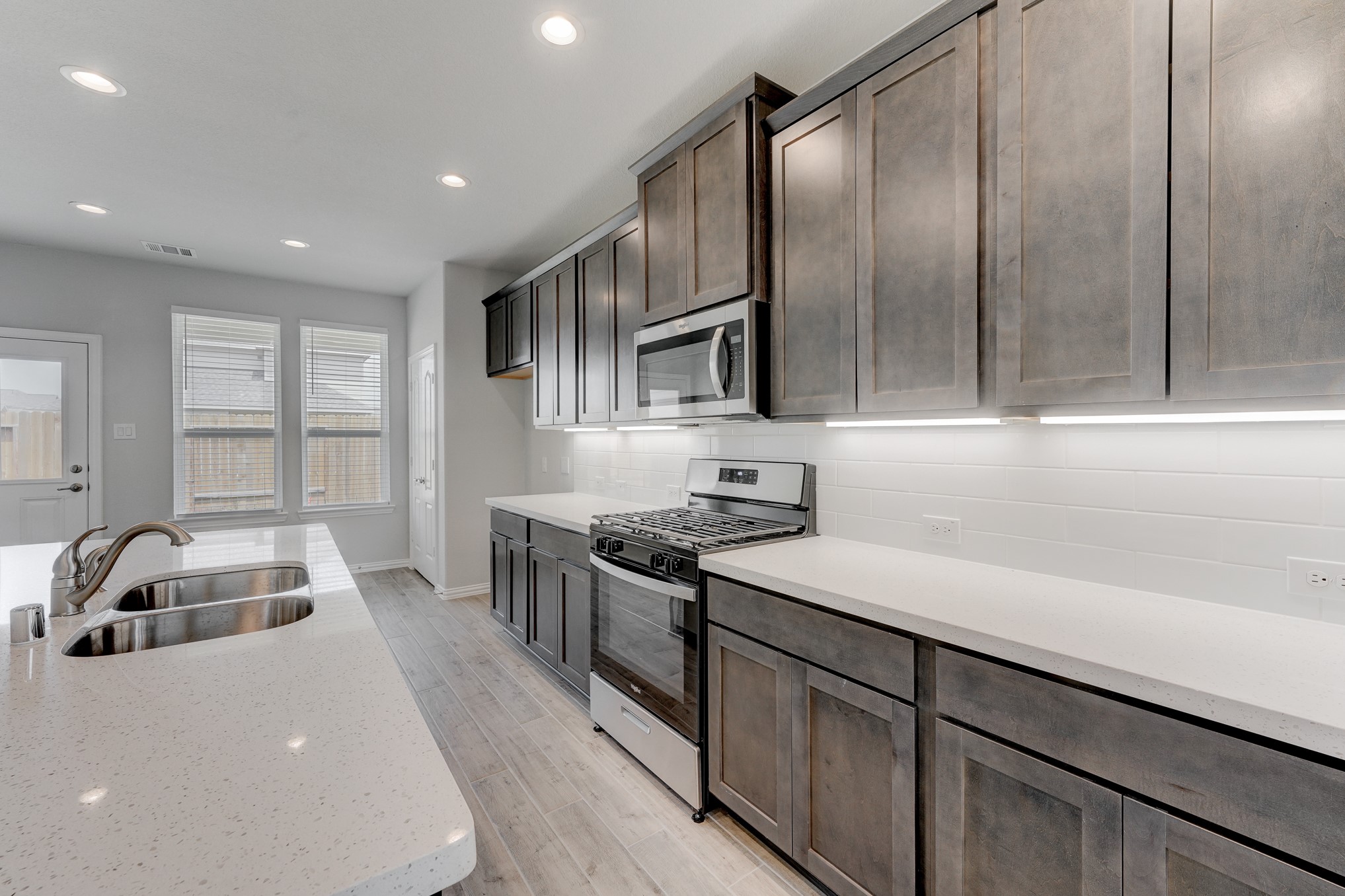 1229 Red Hills Drive Rosharon, TX 77583 - Photo 9 of 29 a kitchen with granite countertop a sink a counter top space stainless steel appliances and cabinets