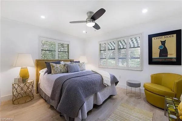 a spacious bedroom with a bed and window