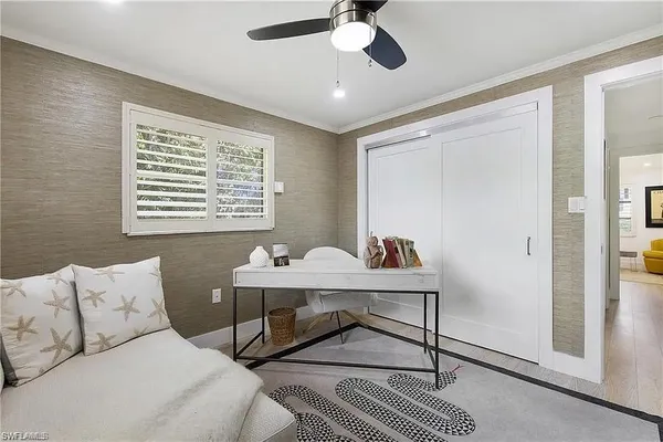 a workspace with a table chair and a window