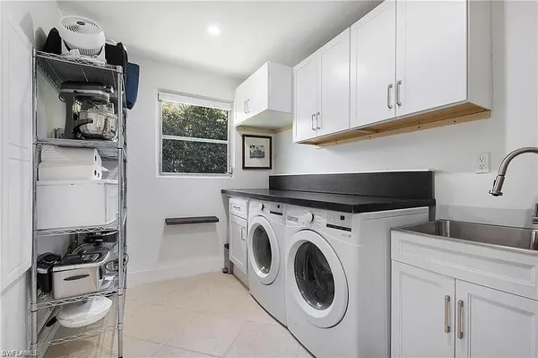 a utility room with sink dryer and washer