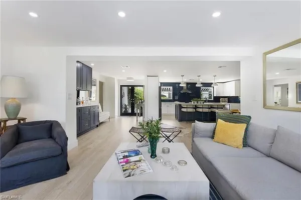 a living room with furniture kitchen view and a table