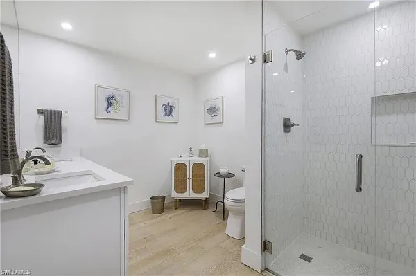 a bathroom with a sink toilet and shower